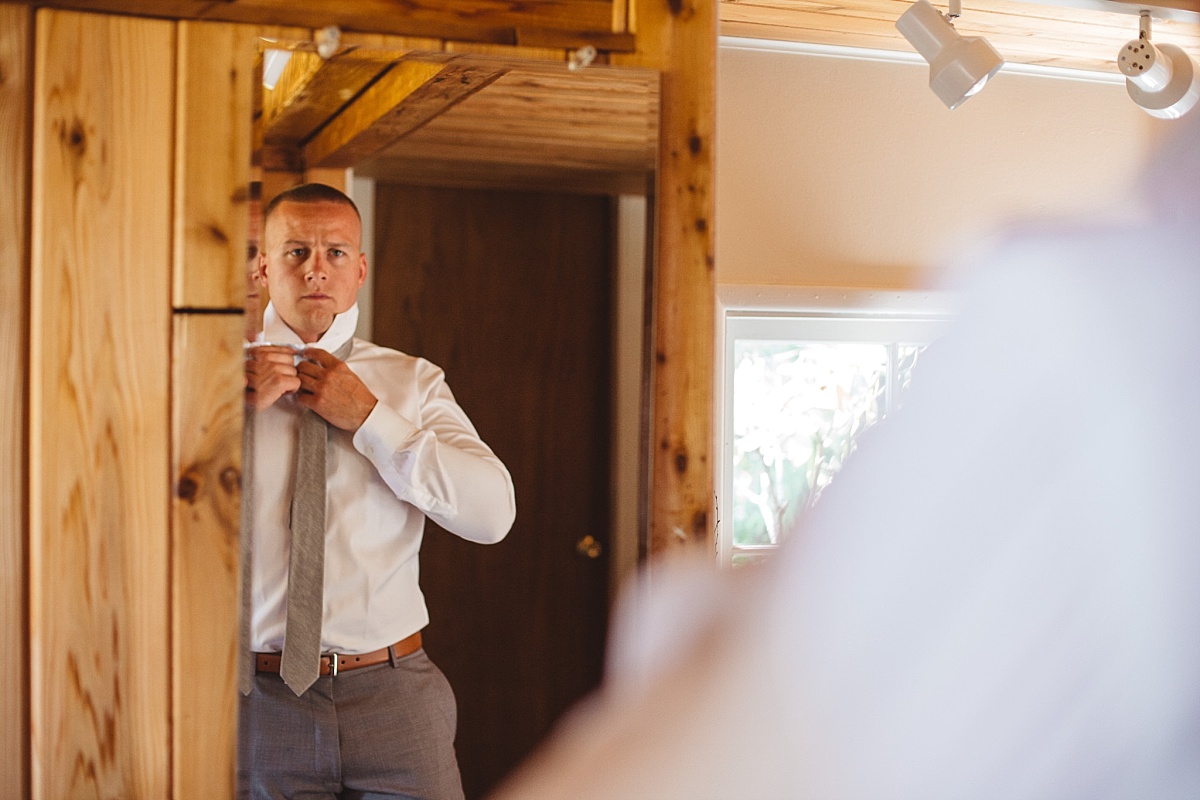 Groom getting ready at Kiana Lodge