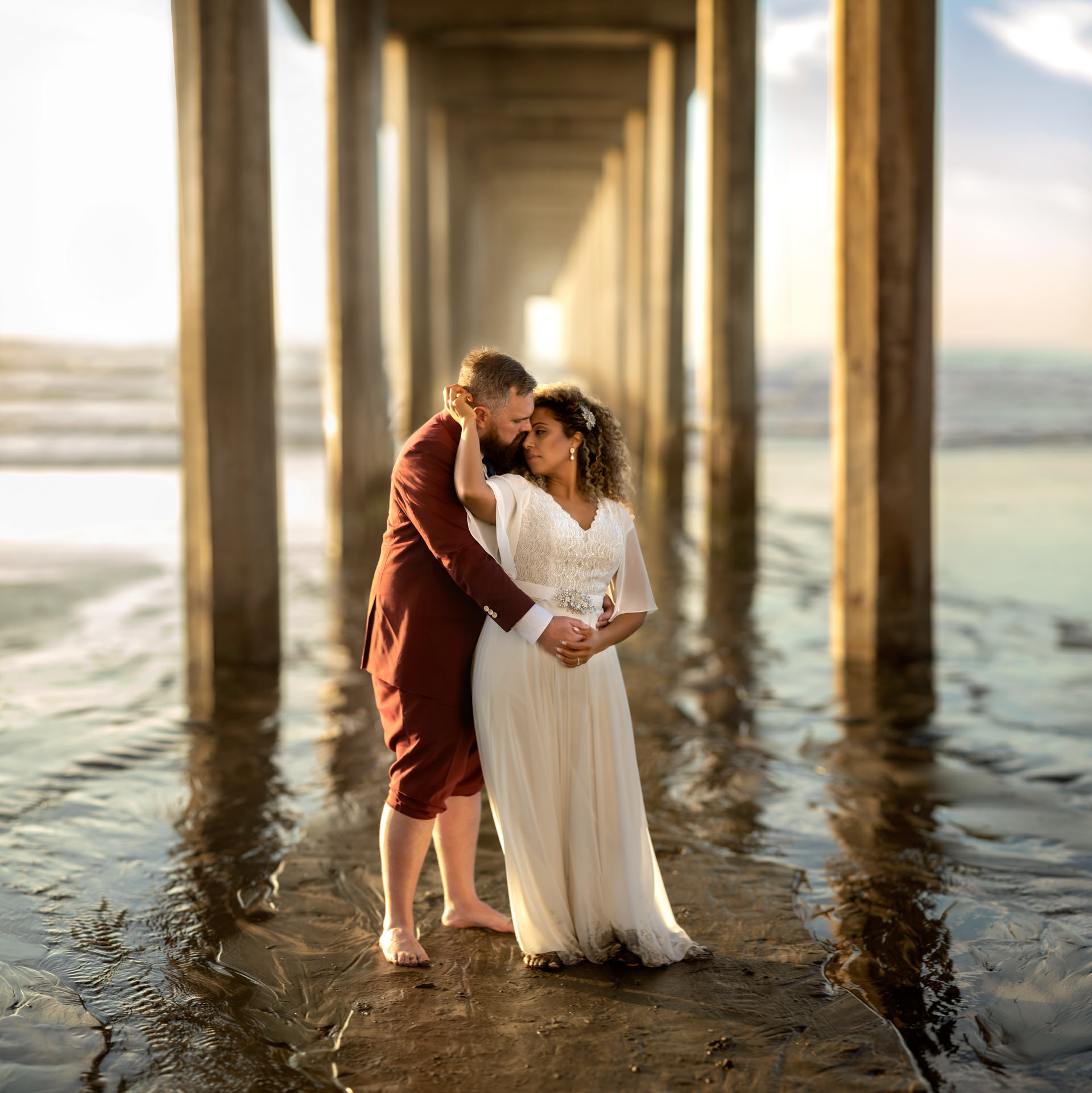 Gerusa and Eric under Scripps Pier Beach Wedding