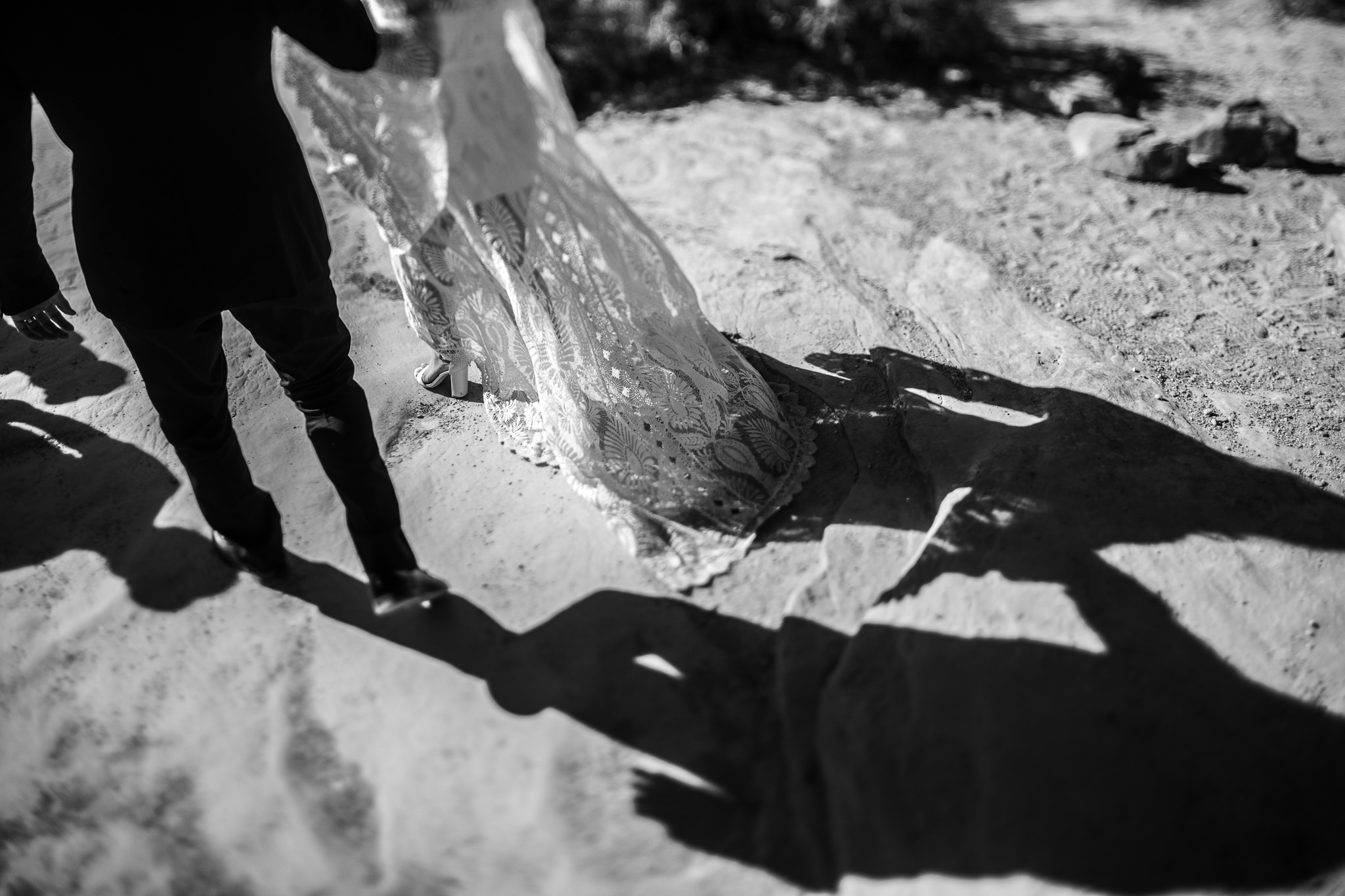 Bride and Groom walking to see double arch