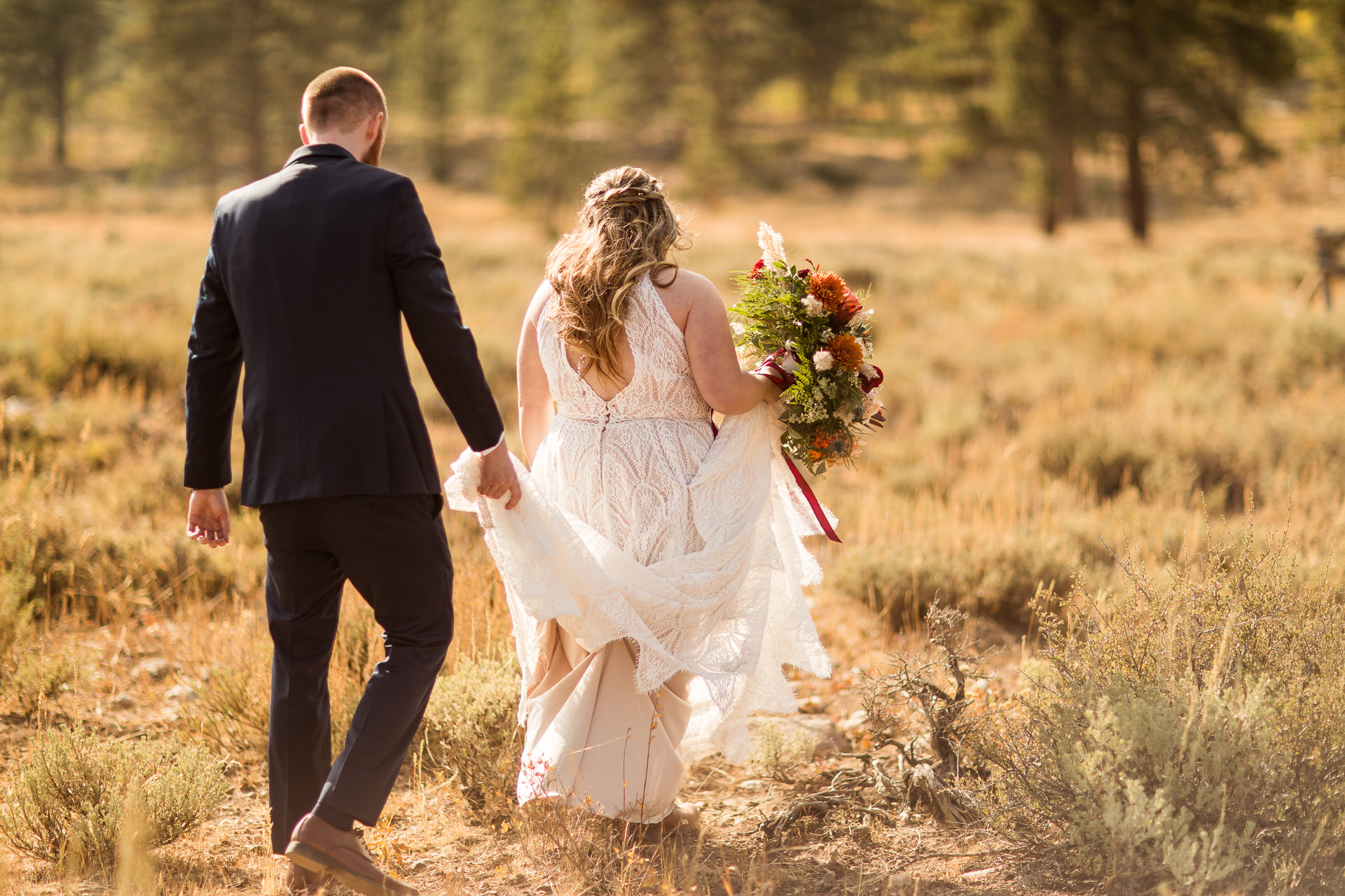 Groom Carries Bride's Dress