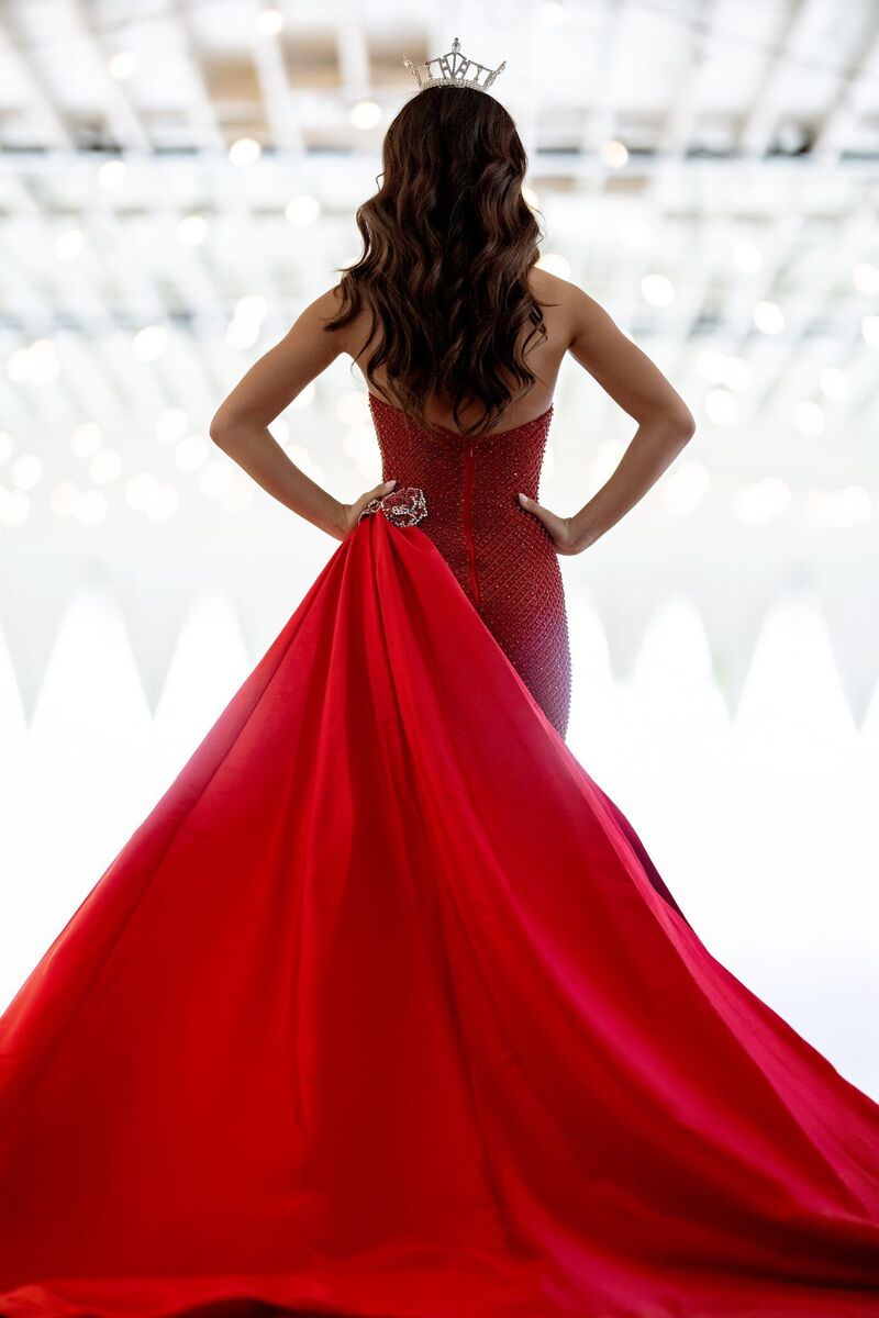 Look one: red gown with a long train, seen from behind