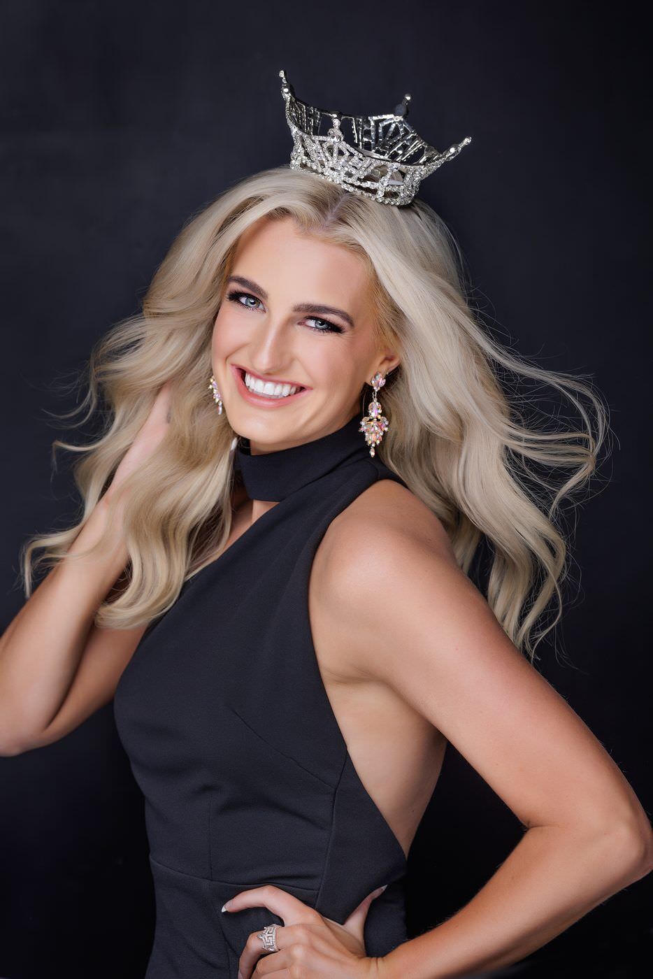 Titleholder with smooth matte skin against a black backdrop
